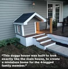 a dog house sitting on top of steps next to a building with stairs leading up to it