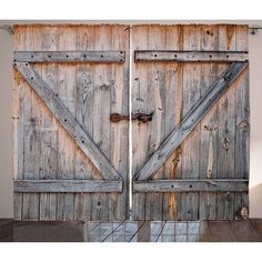 two wooden doors are open in an empty room