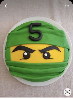 a cake that looks like the face of a teenage mutant ninja on top of a white plate