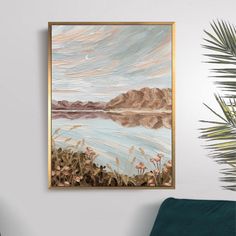 a painting hanging on the wall next to a green chair and potted palm tree