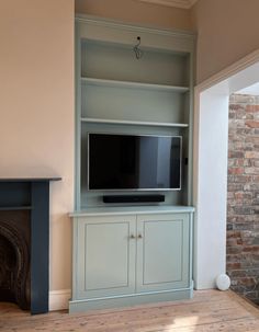 a living room with a fireplace and entertainment center