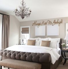 a bedroom with a large bed and wall decal that says and they lived happily ever after