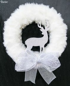 a white wreath with a deer on it