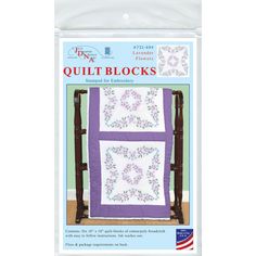 the quilt blocks pattern is shown in purple and white, with flowers on each side