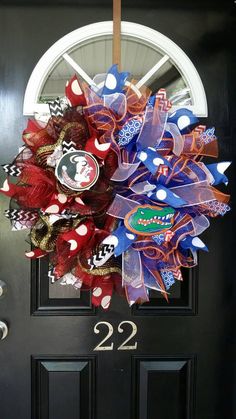 the front door is decorated with red, white and blue deco mesh wreaths that read 22