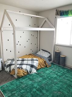 a bedroom with green carpet and white walls