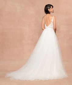 a woman in a white wedding dress looking back