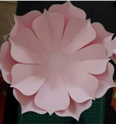 a large paper flower sitting on top of a cutting board