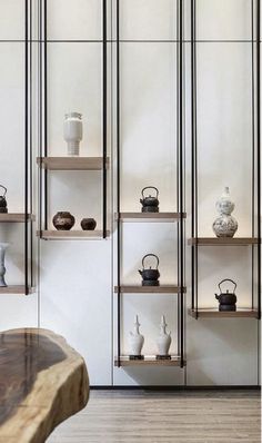 the shelves are filled with teapots and other decorative items on display in this room