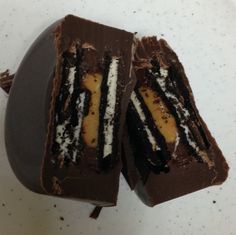 two pieces of chocolate cake sitting on top of a white plate