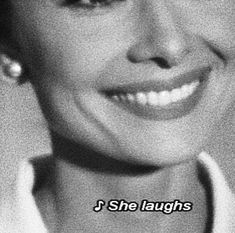 a black and white photo of a smiling woman with the words, i she laughs