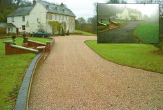 a driveway with gravel leading to a large white house on the side of a road