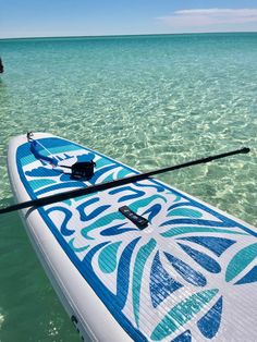 a surfboard is in the water with a person standing on it