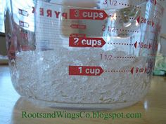 a measuring cup filled with flour on top of a table