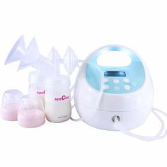 an electric breast pump with three bottles next to it