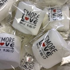 several marshmallows wrapped in cellophane with the words more love on them