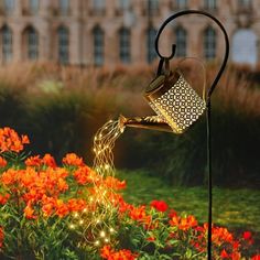 a garden light with flowers in the background