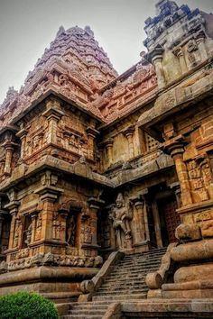 an old stone building with many carvings on the sides and steps leading up to it