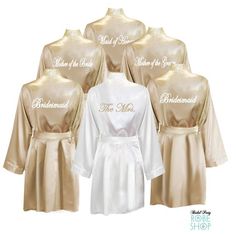 six bridesmaid robes in gold and white with the words maid to be on them