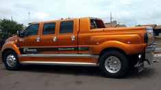 an orange truck parked in a parking lot