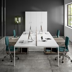 an office with two desks and chairs in front of a large white boardroom