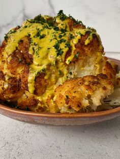 a close up of a plate of food with broccoli and cheese on it