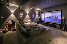 a living room filled with furniture and a flat screen tv mounted to the side of a wall