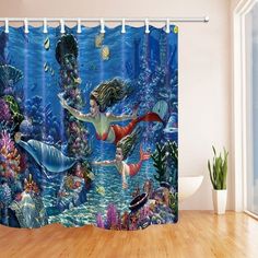 a shower curtain with an image of a mermaid and dolphin swimming in the ocean water