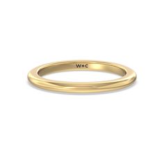 a yellow gold wedding band with the word wlc on it