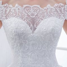 the back of a white wedding dress with lace