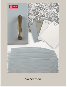 some paint swatches are sitting on top of a white surface with flowers and leaves