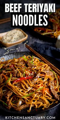 beef teriyaki noodles on a black plate with chopsticks and seasoning