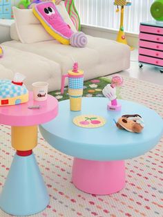 a child's play table with toys on it in a living room area next to a couch