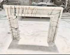 a white marble table sitting on top of a hard wood floor