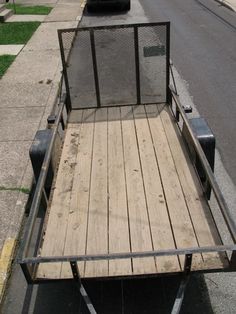 an empty trailer is parked on the side of the road