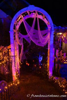 an outdoor halloween light display with purple lights