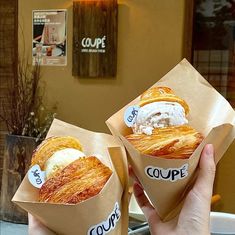 two people holding up some tasty looking pastries in their hands with the words coupe written on them