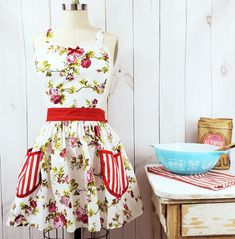 a dress on a mannequin in front of a white wooden wall and bowl