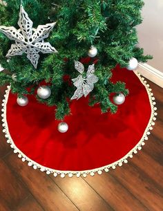 a christmas tree skirt with ornaments on it