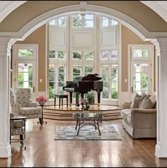 a living room filled with furniture and a grand piano