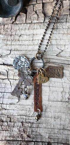 two keys are attached to a chain on a piece of wood with the words, love is