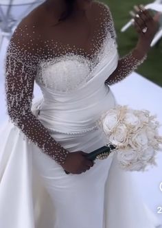 a woman in a wedding dress holding a bouquet