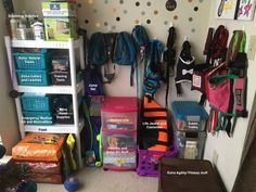 a room filled with lots of luggage and bags next to a wall covered in polka dots