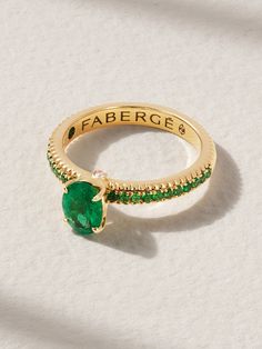 Fabergé's ring is part of the 'Colours of Love' collection that combines vibrant gemstones and impeccable craftsmanship. Handmade from 18-karat gold, it's centered with a 50.50-carat Zambian emerald loved for its pure green color. It's flanked by diamonds above and below and has tonal tsavorites that trace all the way around the slim band. Note the single emerald hidden inside. Faberge Jewelry, Sapphire Eternity Ring, The Bling Ring, Green Stone Rings, Plain Bands, Zambian Emerald, Bling Rings, Pink Ring, Multi Stone Ring