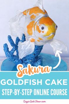 a goldfish cake with blue icing and the words sakra goldfish cake step - by - step online course