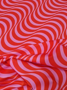 an orange and pink fabric with wavy lines