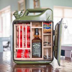 an open suitcase sitting on top of a wooden table filled with bottles and condiments