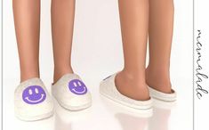 the legs and feet of two people wearing slippers with purple smiley faces on them