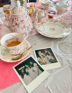 an old fashioned tea set with two pictures on the table