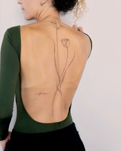 a woman with a flower tattoo on her back